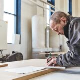Portrait of a busy craftsman working at his workstation