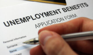Someone completing an unemployment benefits form.