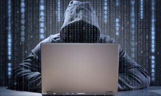 Computer hacker stealing data from a laptop concept for network security, identity theft and computer crime
