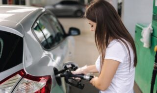 Attractive Young Woman Refueling Car At Gas Station