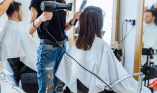 woman drying hair in hair salon