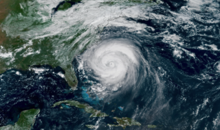 Satellite view of a powerful hurricane with a clearly defined eye near the southeastern U.S. coast in the Atlantic Ocean.